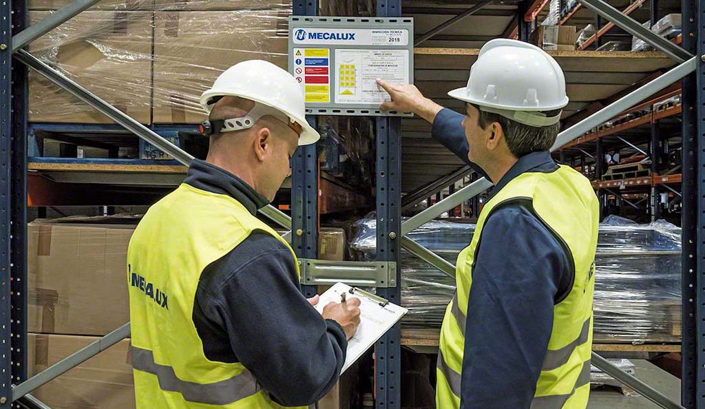 The warehouse safety manager checks the storage systems to ensure that they’re in good condition