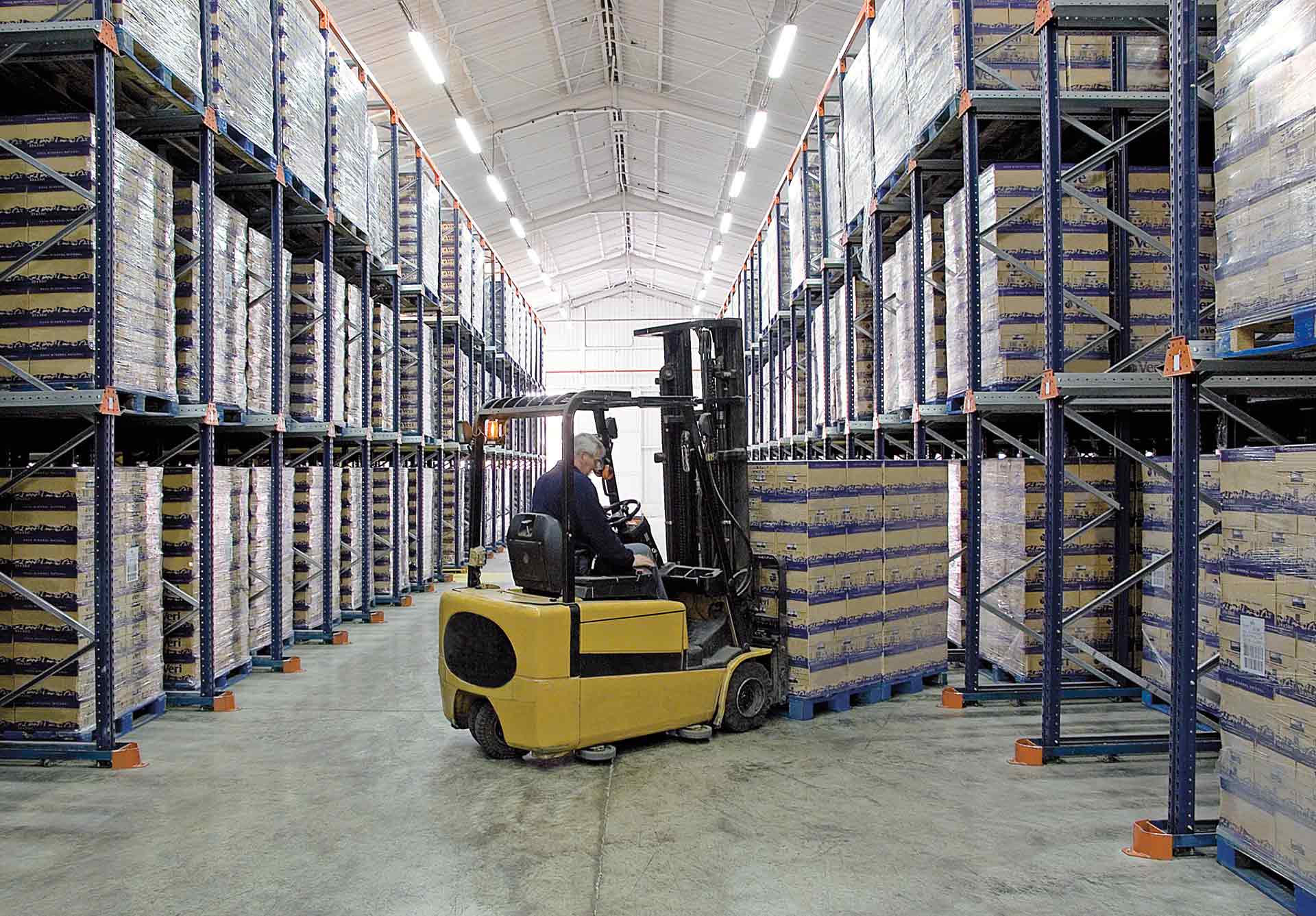 Operator picking up goods with a forklift as an example of a man-to-goods order fulfillment system Operator picking up goods with a forklift as an example of a man-to-goods order fulfillment system