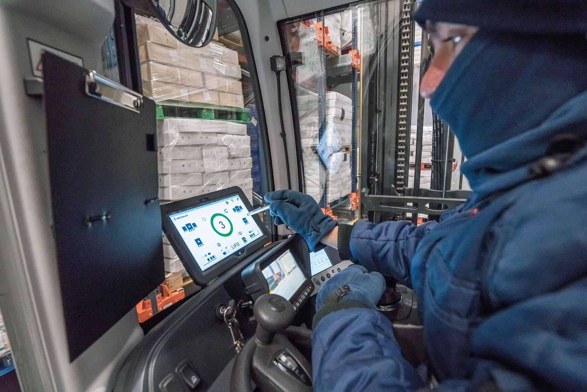 An operator uses a tablet in a cold room