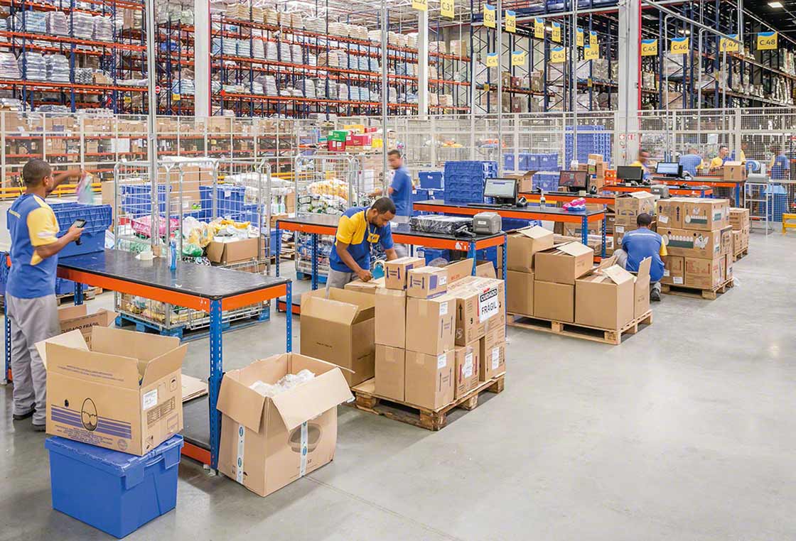 Employees working as a team in a warehouse Employees working as a team in a warehouse