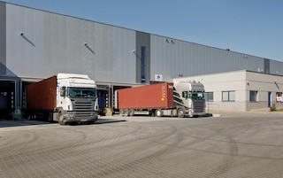 Trucks loading and unloading goods at the warehouse docks