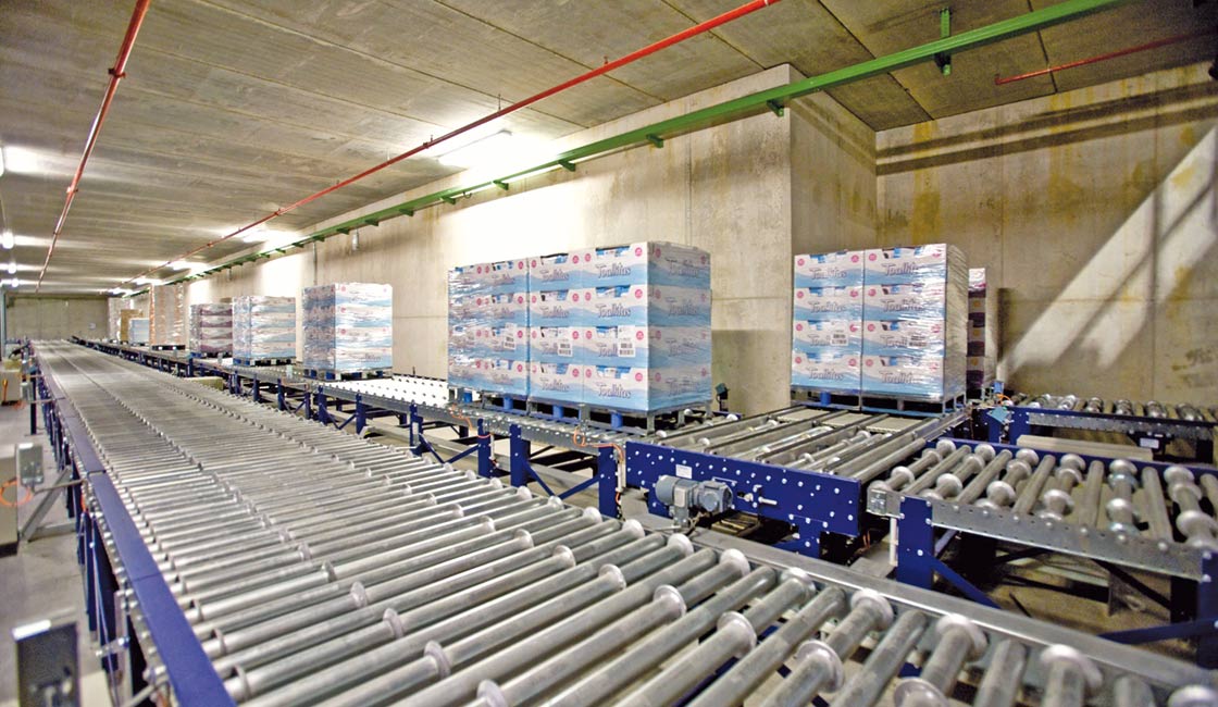 Unlike tugger trains, pallet conveyor systems move large volumes of product uninterruptedly