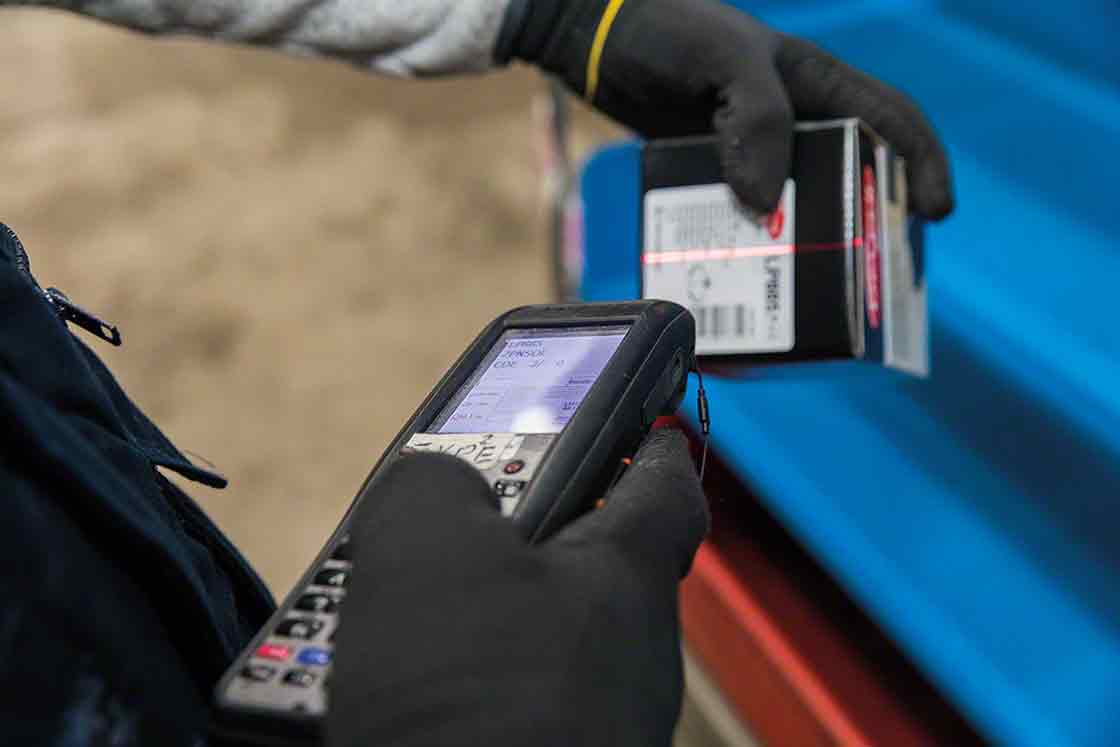 Warehouse operator preparing an order with the help of automated systems Warehouse operator preparing an order with the help of automated systems