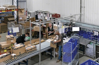 Warehouse workers preparing orders manually