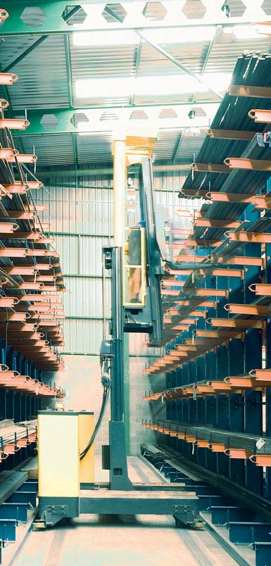 Image of a side-loading reach truck in a warehouse for metal profiles.