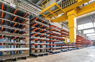Employing automatic overhead cranes speeds up loading and unloading in warehouses with heavy-duty cantilever racks