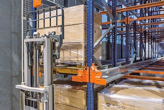 The forklift places the pallet at the entrance to the lane