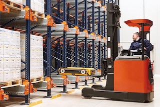 The forklift positions the shuttle at the entrance to the lane