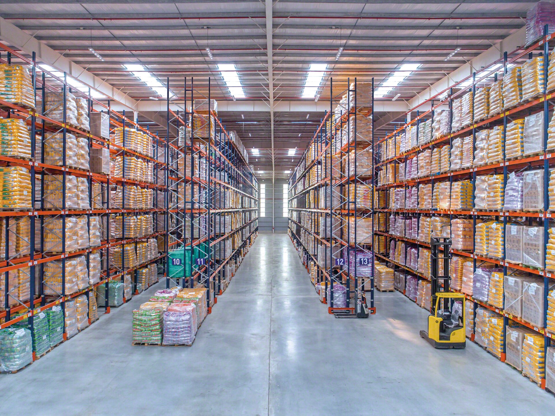 In tall pallet rack warehouses, reach trucks are required to handle the goods