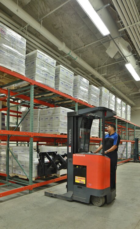 The warehouse staff can now use a smaller sit-down forklift because all of the pallets in the racking are gravity-fed to the front